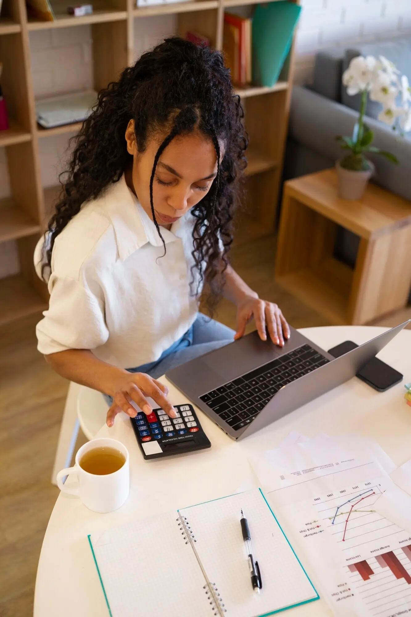 High-angle view of a woman working on a laptop.